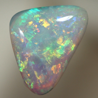 SOLID CRYSTAL OPAL Sparkles of orange and green in a 3D pattern 